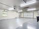 Spacious garage with overhead storage and epoxy floor at 997 Sugar Mill Dr, New Smyrna Beach, FL 32168