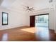 Sunlit living room with hardwood floors and sliding doors at 997 Sugar Mill Dr, New Smyrna Beach, FL 32168