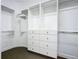 Large walk-in closet with custom shelving and drawers at 997 Sugar Mill Dr, New Smyrna Beach, FL 32168