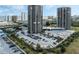 Aerial view of two high-rise buildings with parking and tennis courts at 1 Oceans West Blvd # 5A3, Daytona Beach, FL 32118