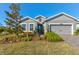 Beautiful house exterior with landscaping and a two-car garage at 1002 Chelan Falls Dr, Deland, FL 32724