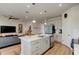 Kitchen island with white cabinets, quartz countertop, and stainless steel sink at 1002 Chelan Falls Dr, Deland, FL 32724