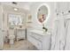 White bathroom with a pedestal sink, toilet and marble floors at 12 Foster Dr, Daytona Beach, FL 32118