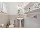 Small bathroom with pedestal sink and gray tile at 12 Foster Dr, Daytona Beach, FL 32118