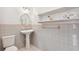 Bathroom with pedestal sink and gray tile at 12 Foster Dr, Daytona Beach, FL 32118