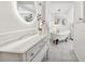 Bathroom with a clawfoot tub, marble floors, and white vanity at 12 Foster Dr, Daytona Beach, FL 32118