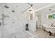 Large bathroom with marble shower, freestanding tub, and separate vanity at 12 Foster Dr, Daytona Beach, FL 32118