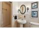 Bathroom with pedestal sink, tiled shower, and vintage details at 12 Foster Dr, Daytona Beach, FL 32118