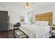 Bedroom with wooden headboard and dark hardwood floors at 12 Foster Dr, Daytona Beach, FL 32118