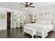 Spacious bedroom with dark hardwood floors, white bedding, and walk-in closet at 12 Foster Dr, Daytona Beach, FL 32118