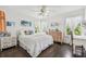 Bedroom with white bedding, dresser, and hardwood floors at 12 Foster Dr, Daytona Beach, FL 32118