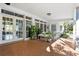 Covered patio with rocking chairs and potted plants at 12 Foster Dr, Daytona Beach, FL 32118