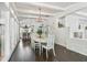 Farmhouse-style dining room with white table and chairs, chandelier, and hardwood floors at 12 Foster Dr, Daytona Beach, FL 32118