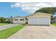 House exterior with two-car garage and landscaping at 12 Foster Dr, Daytona Beach, FL 32118