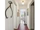 Long hallway with hardwood floors and vintage decor at 12 Foster Dr, Daytona Beach, FL 32118