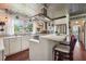 Modern kitchen with white cabinets, tin ceiling, and island with seating at 12 Foster Dr, Daytona Beach, FL 32118