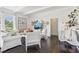 Living room with white sofas, white walls, and dark hardwood floors at 12 Foster Dr, Daytona Beach, FL 32118