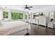 Main bedroom with a king-size bed, dark hardwood floors, and large windows at 12 Foster Dr, Daytona Beach, FL 32118