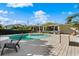 Relaxing kidney-shaped pool and deck; home view at 12 Foster Dr, Daytona Beach, FL 32118