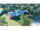 Aerial view of home featuring mature landscaping and metal roof at 1202 12Th St, Edgewater, FL 32132