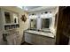 Double vanity bathroom with granite countertops and updated lighting at 1202 12Th St, Edgewater, FL 32132