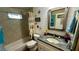 Bathroom with a shower/tub combo, nautical-themed decor, and a vanity with granite top at 1202 12Th St, Edgewater, FL 32132