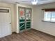 Bright bedroom with decorative closet doors, a ceiling fan, and wood-look flooring at 1202 12Th St, Edgewater, FL 32132