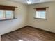 Bright bedroom featuring wood-look flooring, bamboo shades, and ample natural light at 1202 12Th St, Edgewater, FL 32132