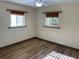 Bright bedroom featuring wood-look flooring, bamboo shades, and ample natural light at 1202 12Th St, Edgewater, FL 32132