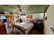 Bedroom featuring wood accent wall, marine themed bedspread, decorative ceiling and light hardwood floors at 1202 12Th St, Edgewater, FL 32132