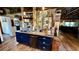 Kitchen island with a farmhouse sink, granite countertops, and open shelving at 1202 12Th St, Edgewater, FL 32132