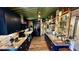 Long view of a kitchen with dark blue cabinets, granite countertops, and stainless steel appliances at 1202 12Th St, Edgewater, FL 32132