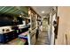 Galley kitchen featuring black cabinetry and stainless steel appliances with a decorative hallway entrance at 1202 12Th St, Edgewater, FL 32132