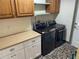 Well-equipped laundry room featuring modern washer and dryer, countertop, and ample cabinet space at 1202 12Th St, Edgewater, FL 32132