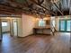 Inviting living room featuring wood floors, custom bar, unique lighting, and exposed architectural details at 1202 12Th St, Edgewater, FL 32132