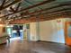 Open-concept living room with hardwood floors, wood beams, and lots of natural light at 1202 12Th St, Edgewater, FL 32132