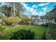 Spacious backyard with lush lawn and a metal art feature at 1207 Magnolia St, New Smyrna Beach, FL 32168