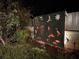 Backyard with illuminated metal art feature at night at 1207 Magnolia St, New Smyrna Beach, FL 32168