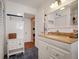 Bright bathroom with white cabinets, granite countertop, and a large mirror at 1207 Magnolia St, New Smyrna Beach, FL 32168