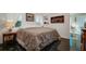 King size bed in bright bedroom with dark tile floors at 1207 Magnolia St, New Smyrna Beach, FL 32168