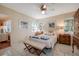 Bedroom with tiled floors, ceiling fan and wooden furniture at 1207 Magnolia St, New Smyrna Beach, FL 32168