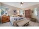 Comfortable bedroom with a queen-size bed and antique wooden dresser at 1207 Magnolia St, New Smyrna Beach, FL 32168