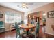 Charming dining room with a round table, teal chairs, and views into the living room at 1207 Magnolia St, New Smyrna Beach, FL 32168