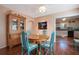 Bright dining room features a wood table with teal chairs and built-in cabinetry at 1207 Magnolia St, New Smyrna Beach, FL 32168