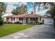 Single story house with red tile roof, landscaping, and a spacious yard at 1207 Magnolia St, New Smyrna Beach, FL 32168