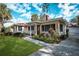 Single story house with red tile roof, landscaping, and a spacious yard at 1207 Magnolia St, New Smyrna Beach, FL 32168