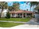 One-story house with red tile roof, green lawn, and a driveway at 1207 Magnolia St, New Smyrna Beach, FL 32168