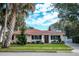 Charming single-story house with red tile roof, landscaping, and a spacious yard at 1207 Magnolia St, New Smyrna Beach, FL 32168