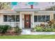 House exterior featuring a wood door and well-maintained landscaping at 1207 Magnolia St, New Smyrna Beach, FL 32168