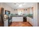 Modern kitchen with white cabinets, granite counters, and stainless steel appliances at 1207 Magnolia St, New Smyrna Beach, FL 32168